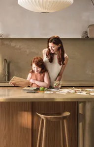 Mother and daughter standing in the kitchen near a Caesarstone mineral surface